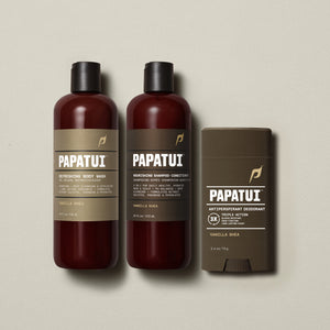 PAPATUI™ Body Care Bundle in Vanilla Shea scent, featuring the full set: Refreshing Body Wash 18 fl oz, Nourishing Shampoo + Conditioner 18 fl oz, and Antiperspirant Deodorant 2.6 oz. Products are arranged on a soft beige background, showcasing consistent amber and brown minimalist packaging with bold PAPATUI™ branding.