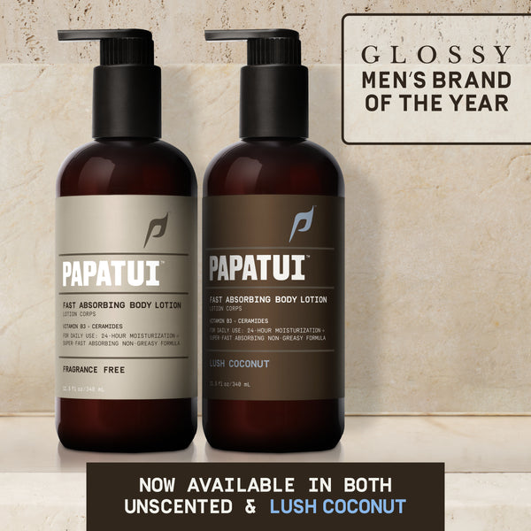 PAPATUI™ Fast Absorbing Body Lotion 11.5oz Hydrating men's body lotion enriched with Vitamin B3 and ceramides for 24-hour moisturization. Designed for daily use with a fast-absorbing, non-greasy formula. The image features two amber bottles with black pump dispensers, showcasing the Fragrance-Free and Lush Coconut variations. A "Glossy Men's Brand of the Year" badge in the top right corner highlights the brand's recognition. Bold text at the bottom states, "NOW AVAILABLE IN BOTH UNSCENTED & LUSH COCONUT.