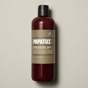 A bottle of Refreshing Body Wash with the brand name PAPATUI on it, indicating it is a product for body and hair care.