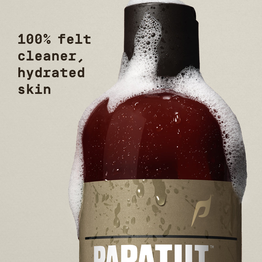Body wash bubbles on bottle with "100% felt cleaner, hydrated skin" text overlay - Papatui Body Wash