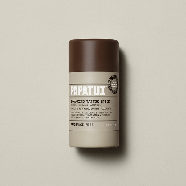 PAPATUI™ Enhancing Tattoo Stick (Fragrance-Free) 2.6 oz stick shown standing alone on a neutral beige backdrop. Fragrance-free formula helps revitalize and protect tattoos with mango butter and coconut oil.