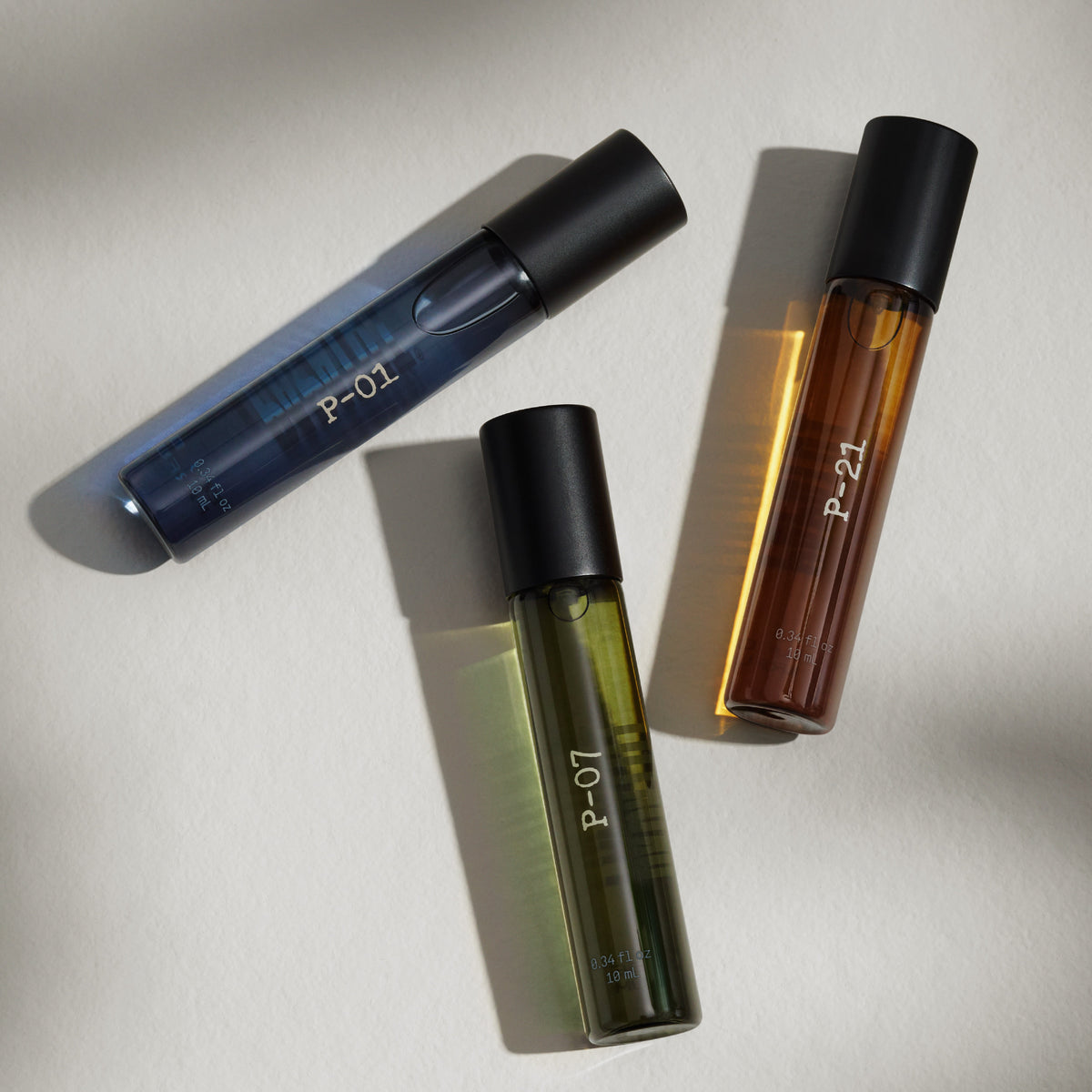 Three PAPATUI Luxury Cologne Discovery Set bottles - P-01 (blue), P-07 (green), P-21 (amber) on a white background