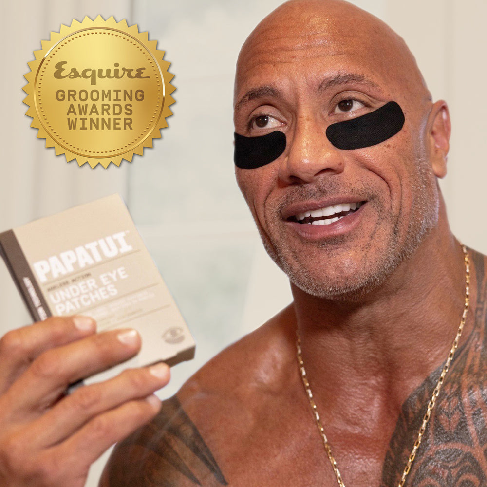 Dwayne "The Rock" Johnson wearing and holding PAPATUI Under Eye Patches against a neutral background with a gold award badge in the top left corner that reads "Esquire Grooming Awards Winner"