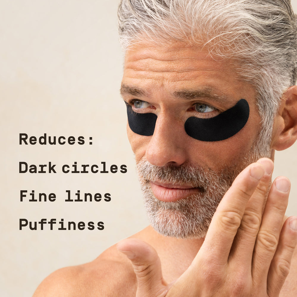 Man with PAPATUI Under Eye Patches against a neutral background with text overlay that reads "Reduces: Dark circles Fine lines Puffiness"