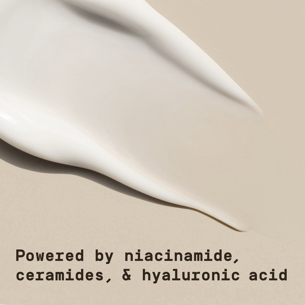 Close-up of Papatui Restoring Facial Moisturizer smeared on a neutral background with text overlay that reads "Powered by niacinamide, ceramides, & hyaluronic acid"