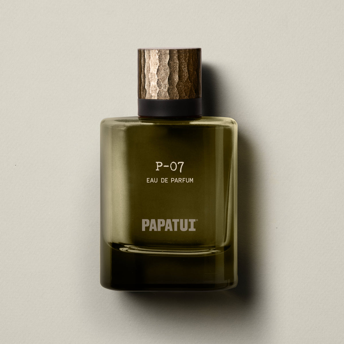 Green cologne bottle labeled 'P-07 Eau de Parfum' by 'PAPATUI' on a neutral background