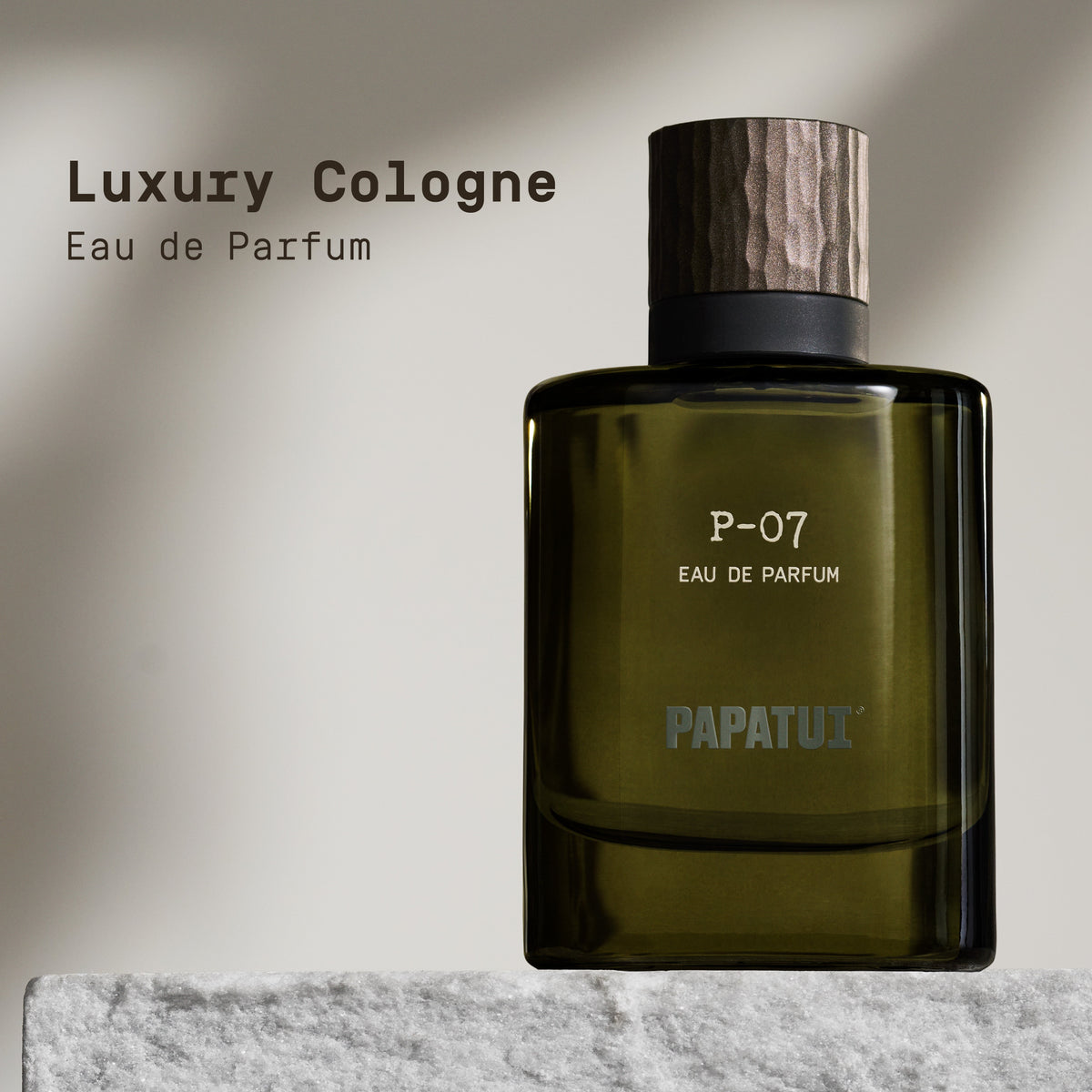 Green cologne bottle labeled 'P-07 Eau de Parfum' by PAPATUI on a marble surface with a neutral background with text overlay that reads "Luxury Cologne Eau de Parfum"