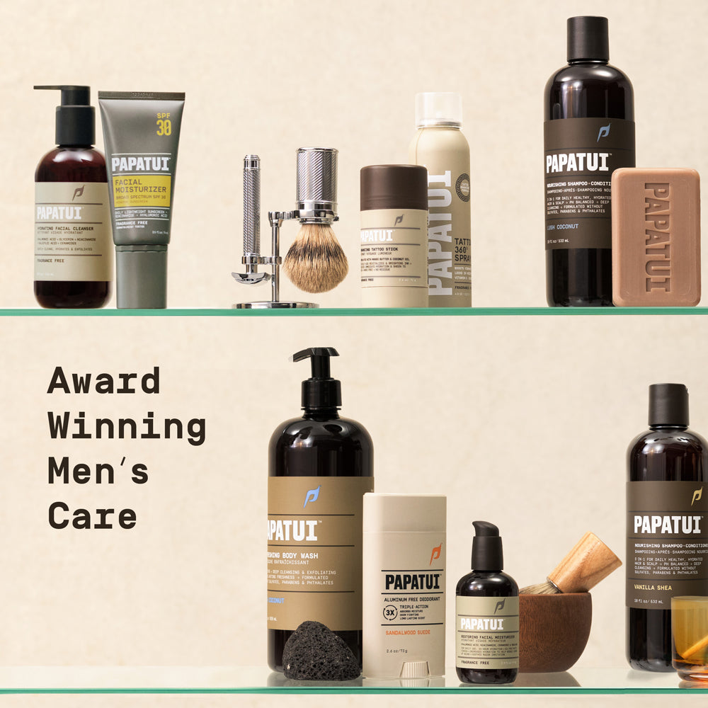 Assortment of PAPATUI products sitting on two vertical glass shelves against a neutral background with text overlay reading "Award Winning Men's Care"