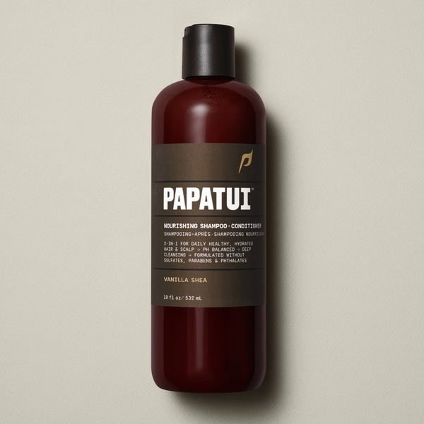 PAPATUI™ Nourishing Shampoo + Conditioner bottle in Vanilla Shea scent, 18 fl oz size. The product features a rich amber bottle with a minimalist dark brown label, showcasing clean branding and clear ingredient highlights.
