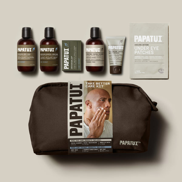 Papatui Holiday gift set facial care dopp kit with Dwayne the Rock Johnson on the belly band. Gift set includes men's hydrating facial cleanser, restoring facial moisturizer, and under eye patches and Papatui lush coconut mini body wash, shampoo and conditioner, and bar soap all in travel sizes.