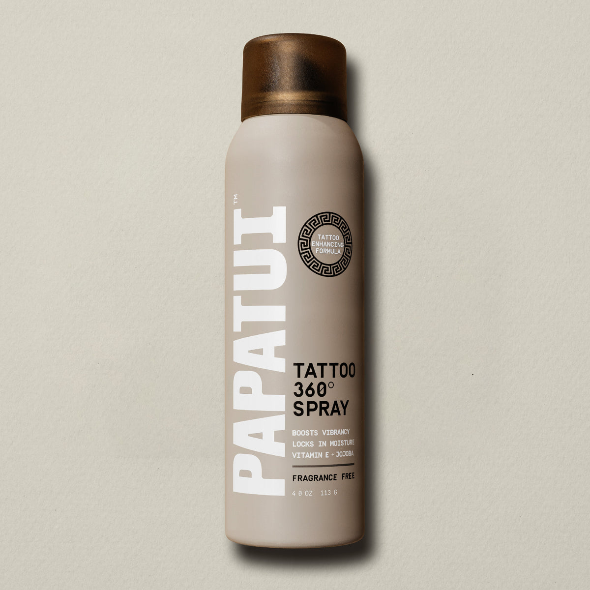 Beige PAPATUI Tattoo 360 Spray bottle on a beige background
