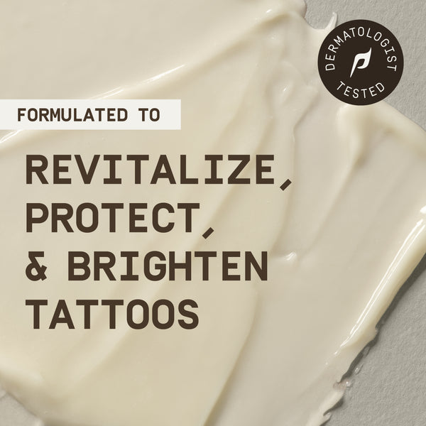 Close-up of PAPATUI™ Enhancing Tattoo Balm's smooth, creamy texture spread across a neutral background, emphasizing its rich and hydrating formulation. Bold text overlay reads, 'Formulated to Revitalize, Protect, & Brighten Tattoos,' highlighting its key benefits. A circular badge in the top right corner states 'Dermatologist Tested,' reinforcing the product's credibility and skin-safe formulation. The image conveys the balm’s nourishing properties designed to enhance tattoo vibrancy and longevity.