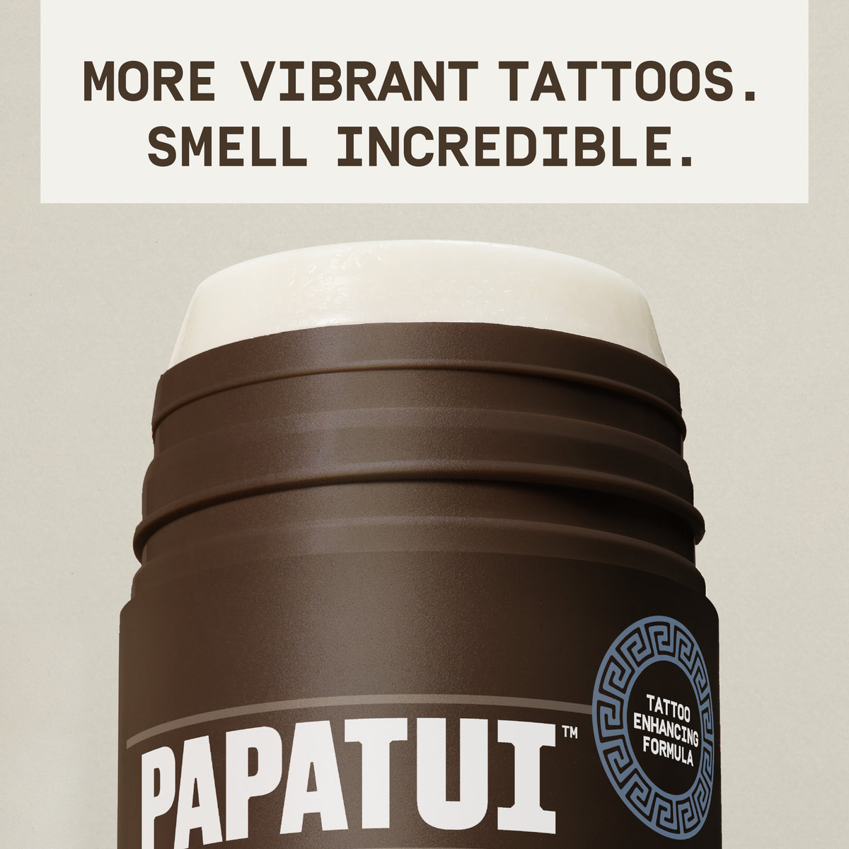 Close-up of PAPATUI™ Enhancing Tattoo Stick Coconut Woods 2.6 oz stick twisted up showing creamy texture. Text overlay says: “More vibrant tattoos. Smell incredible.”