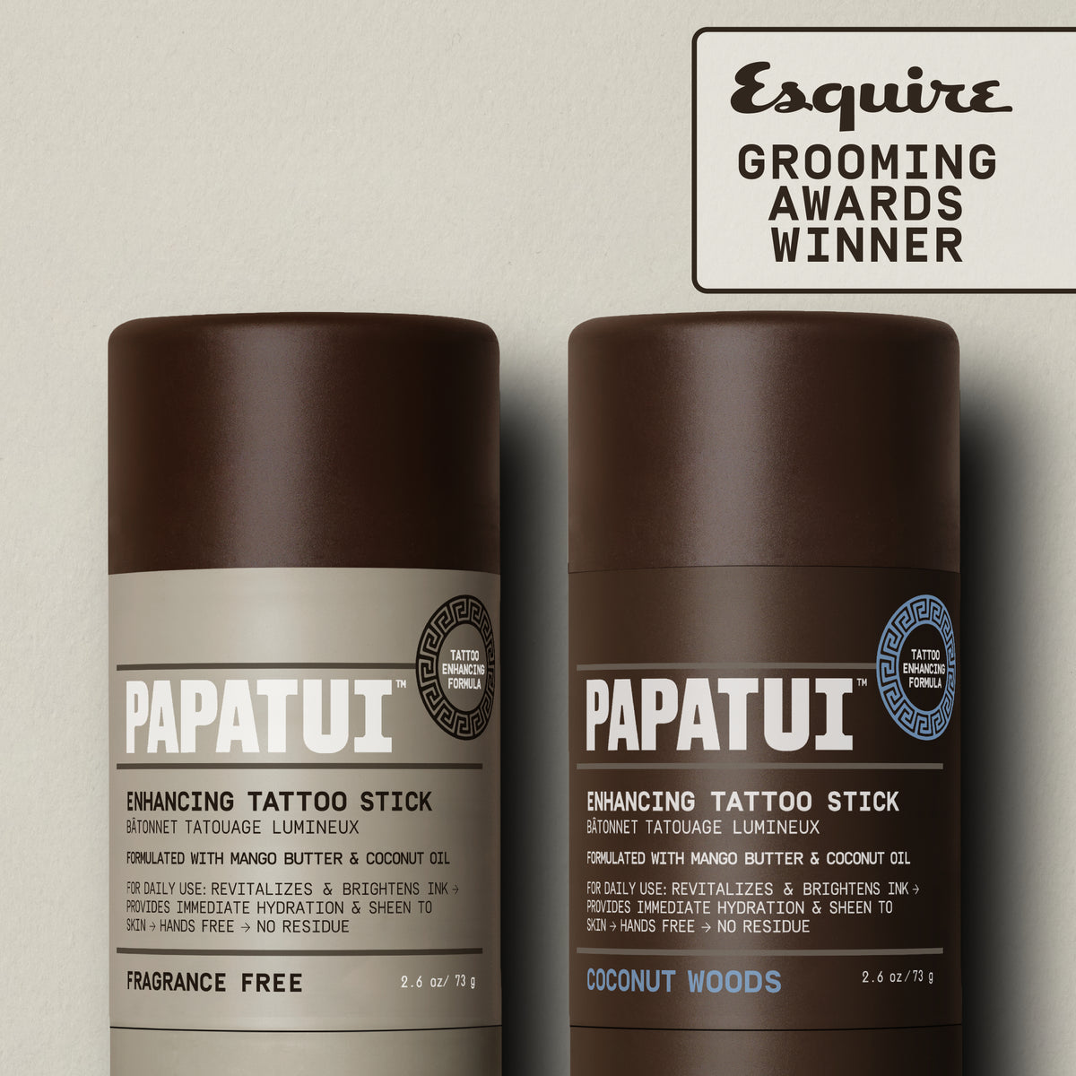 PAPATUI™ Enhancing Tattoo Stick Duo
featuring the Unscented and Coconut Woods 2.6 oz sticks displayed upright. Features Esquire Grooming Awards Winner badge. Products are designed to brighten tattoo ink and hydrate skin with mango butter and coconut oil.