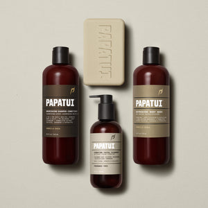 Group display of the full PAPATUI™ Ultimate Shower Bundle in Vanilla Shea scent. Includes Hydrating Facial Cleanser, Vanilla Shea Nourishing Shampoo + Conditioner, Vanilla Shea Refreshing Body Wash, and Vanilla Shea Enriching Big Bar Soap, all set against a soft beige background.