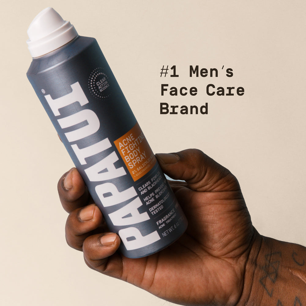 Hand holding a PAPATUI Acne Fighting Body spray with text about it the brand being the #1 men's face care brand.
