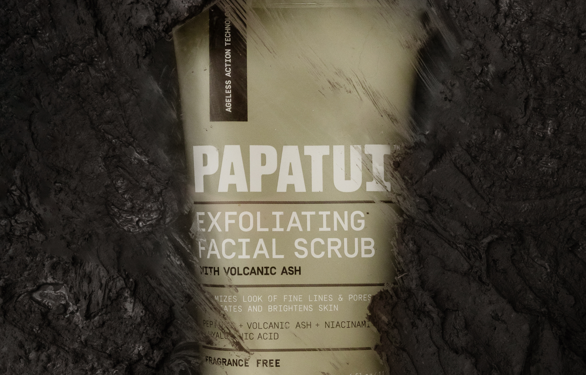 PAPATUI Exfoliating Facial Scrub with volcanic ash on a dark textured background