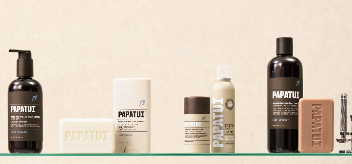 Assortment of PAPATUI products a glass shelf against a beige background