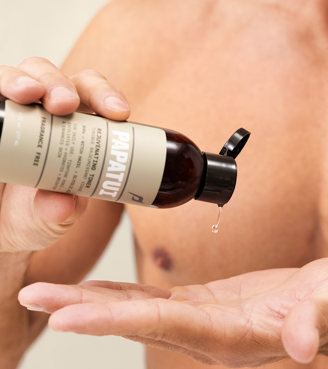 Man pouring PAPATUI Rejuvenating Toner into his hand