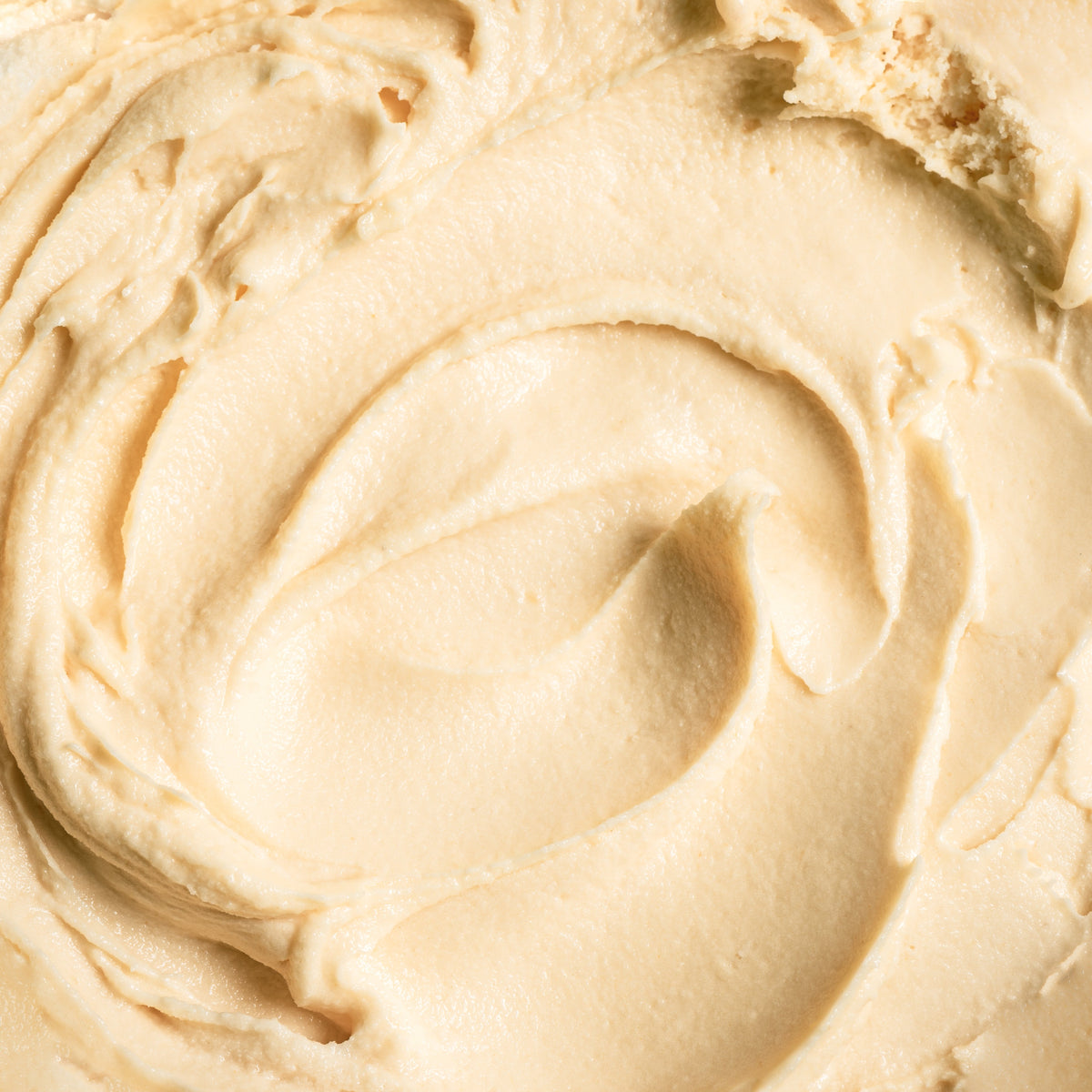 Close-up of creamy beige substance with a swirl pattern