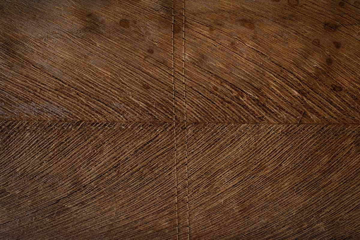 Close-up of a wooden floor with a herringbone pattern