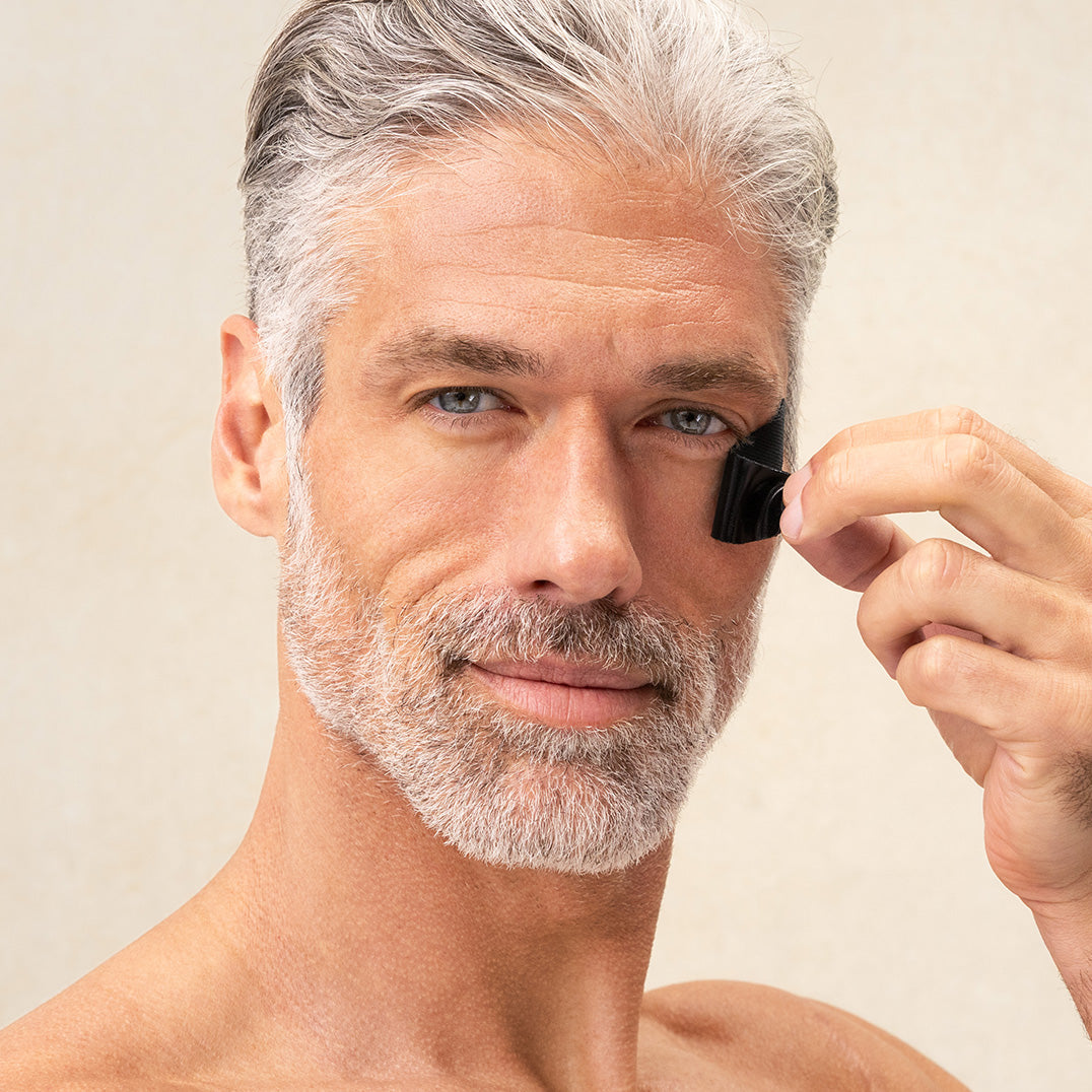 Man removing PAPATUI Eye Patches against a neutral background