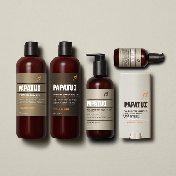 Papatui Body wash, shampoo and conditioner, deodorant in the scent sandalwood suede and unscented body lotion and facial moisturizer lined up on a beige background.