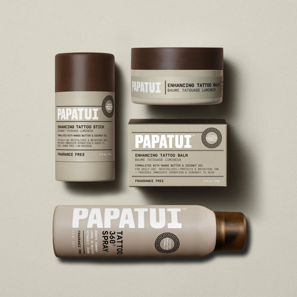 Papatui unscented tattoo stick, tattoo spray and unscented tattoo balm lined up on a plain beige background.