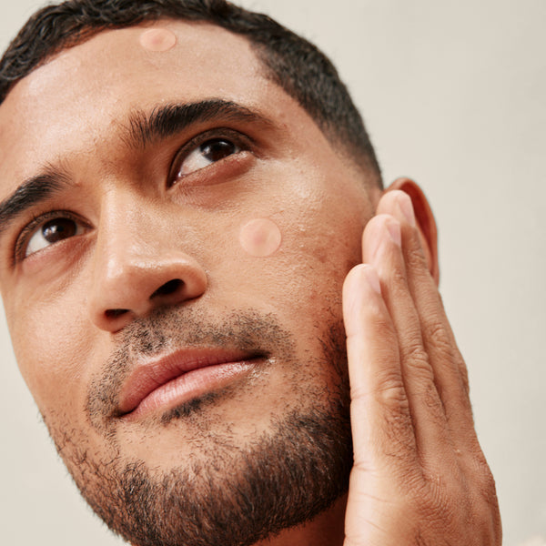 This image shows a man using Papatui Pimple Patches.