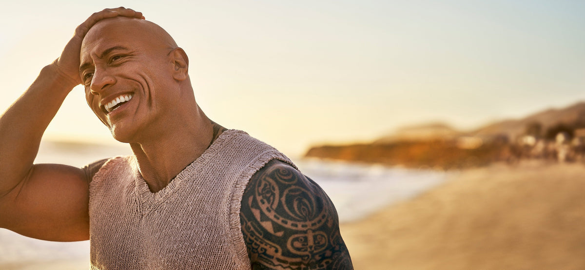 Dwayne "The Rock" Johnson smiling on a beach