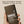Papatui antiperspirant deodorant stick held in a hand with promotional text on a beige background