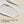 A stroke of Papatui Fast Absorbing lotion on a beige background with text 'Powered by vitamin B3 & ceramides'.