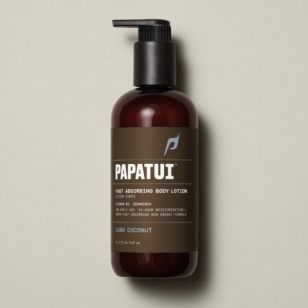 PAPATUI™ Lush Coconut Fast Absorbing Body Lotion 11.5 fl oz Hydrating men's body lotion enriched with Vitamin B3 and ceramides for 24-hour moisturization. Designed for daily use with a super fast-absorbing, non-greasy formula. The image features a sleek amber bottle with a black pump dispenser, and a brown label with bold white typography displaying the PAPATUI™ logo. The "Lush Coconut" scent is highlighted, emphasizing a nourishing and refreshing fragrance.