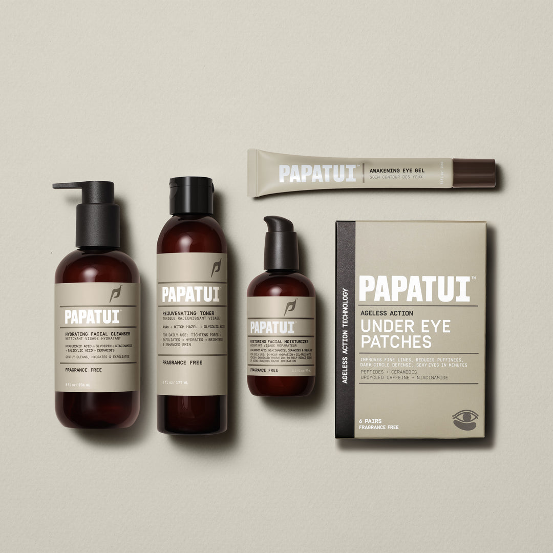 PAPATUI™ Complete Face Care Bundle featuring five products laid flat: Hydrating Facial Cleanser, Rejuvenating Toner, Restoring Facial Moisturizer, Awakening Eye Gel, and Ageless Action Under Eye Patches. Products are displayed with consistent amber packaging and beige branding.