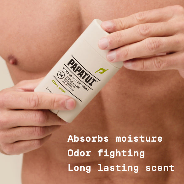 Person holding a Papatui deodorant stick with text highlighting features: absorbs moisture, fights odor, and has a long lasting scent.