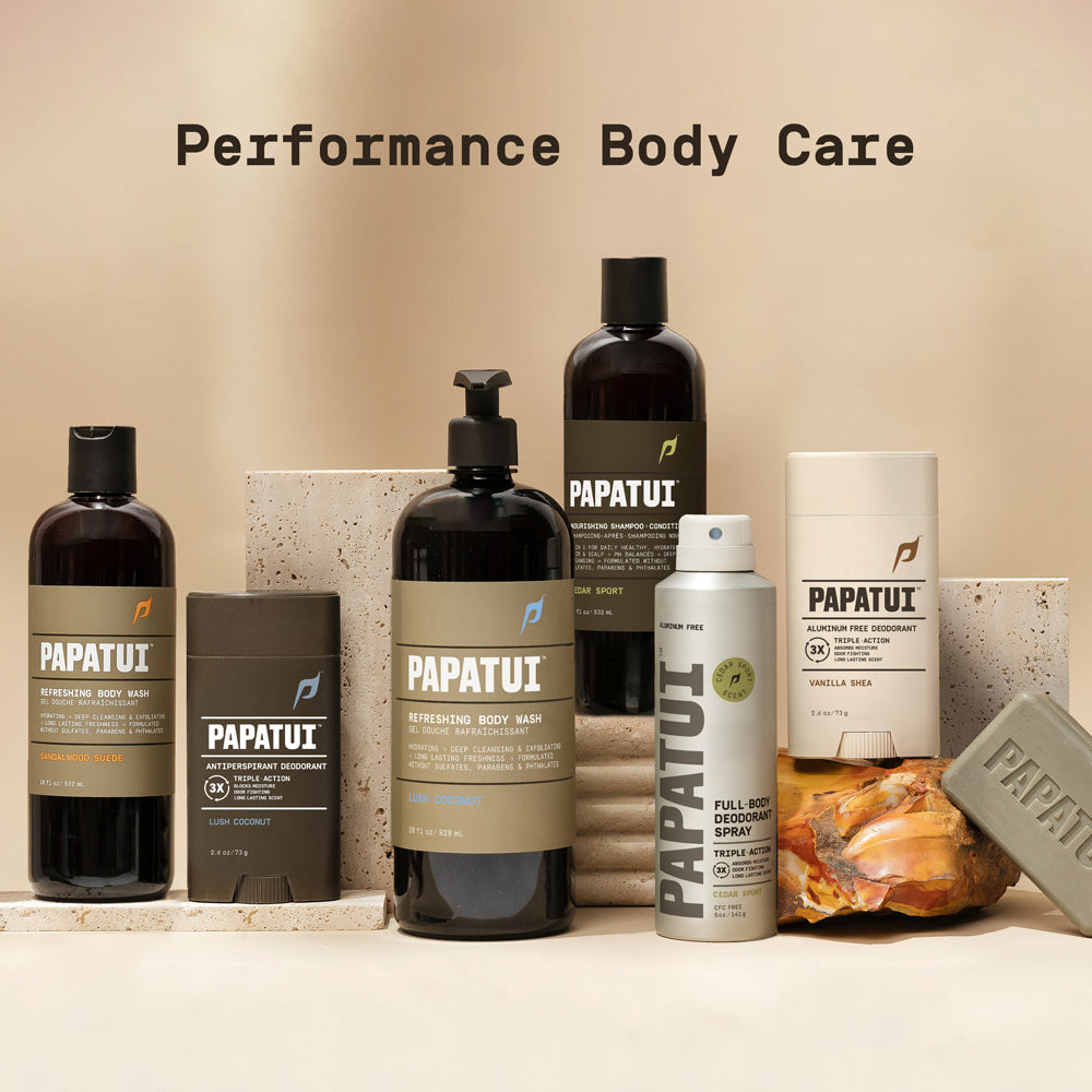 Assortment of PAPATUI products sitting on a white counter against a neutral background with text overlay reading "Performance body care"