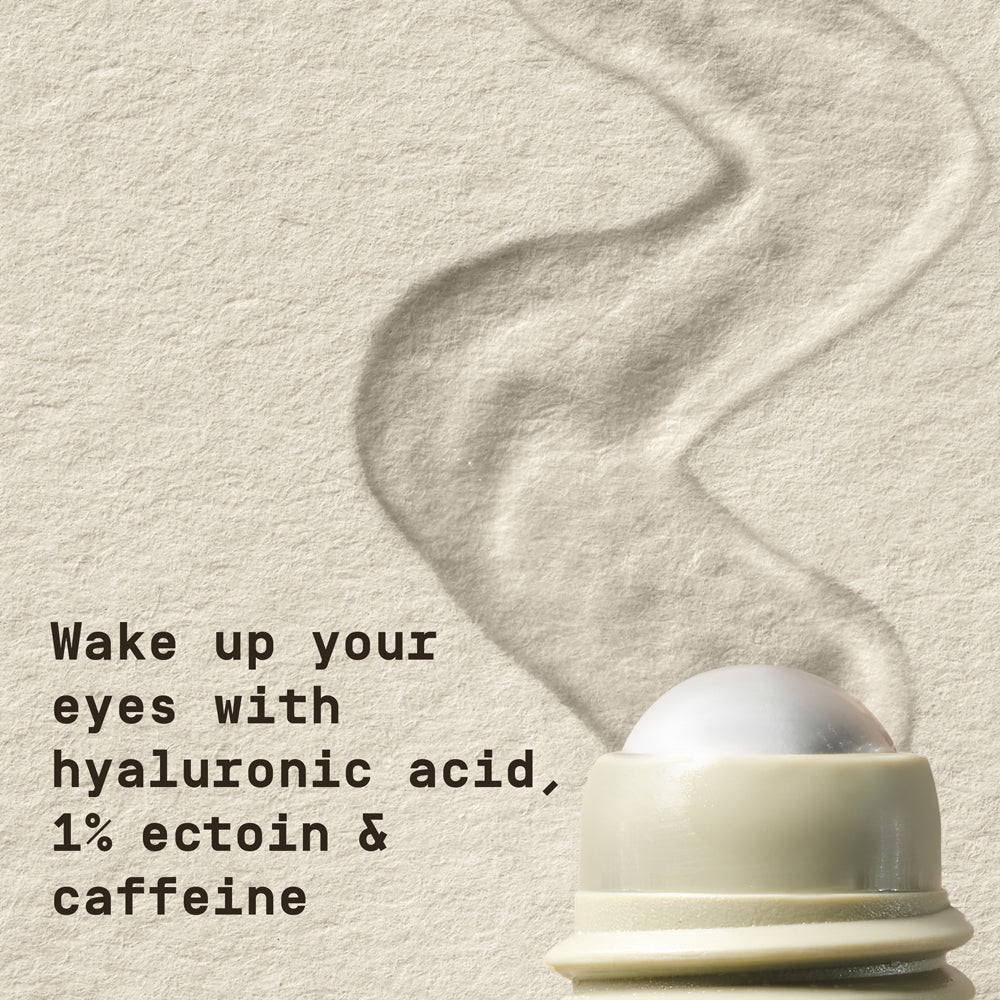 Close-up of PAPATUI Awakening Eye Gel rolling on a piece of white paper background with text overlay that reads "Wake up your eyes with hyaluronic acid, 1% ectoin & caffeine"
