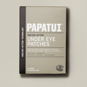 PAPATUI™ Ageless Action Under Eye Patches A sleek beige and black box of PAPATUI™ Ageless Action Under Eye Patches highlighting key benefits: improves fine lines, reduces puffiness, dark circle defense with peptides, ceramides, upcycled caffeine, and niacinamide. Contains 6 pairs, fragrance-free.