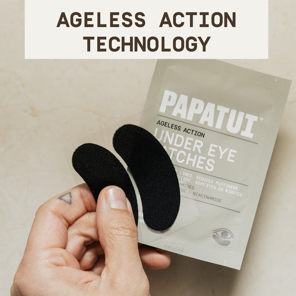 PAPATUI™ Ageless Action Under Eye Patches hand holding two PAPATUI™ Under Eye Patches next to a sachet of the product. Bold text reads "Ageless Action Technology," highlighting the science-backed formulation.