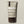 PAPATUI™ Exfoliating Mens Facial Scrub unscented 4oz tube. The packaging features a beige and brown design with bold white text. It highlights key ingredients like volcanic ash, peptides, niacinamide, and hyaluronic acid, promoting exfoliation, brightening, and minimizing fine lines and pores. The label also states ‘Fragrance Free’ and ‘Ageless Action Technology.