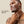Man applying cleanser to his face with a beige background and text 'Use Daily AM/PM'.