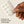 Hand holding a sheet of hydrocolloid patches with text 'Powered by Hydrocolloid Technology'. - Papatui Pimple Patches