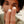 Close-up of a person's hand holding two small white objects with text '2 sizes' on a blurred background. - Papatui Pimple Patches