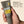 Man holding a tube of Papatui Men's daily moisturizer SPF with tan  background with text reading 
