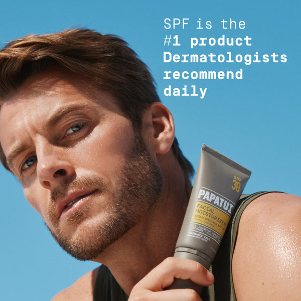 Man holding a tube of Papatui Men's daily moisturizer SPF with a blue background and Skin Cancer Foundation logo with text reading "SPF is the #1 product Dermatologists recommend daily."