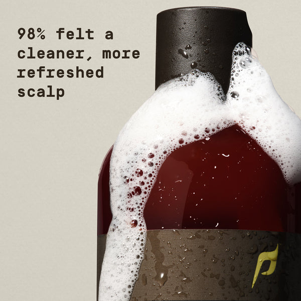 Bottle of shampoo with foamy head and text about scalp benefits on a beige background - Papatui Shampoo and Conditioner