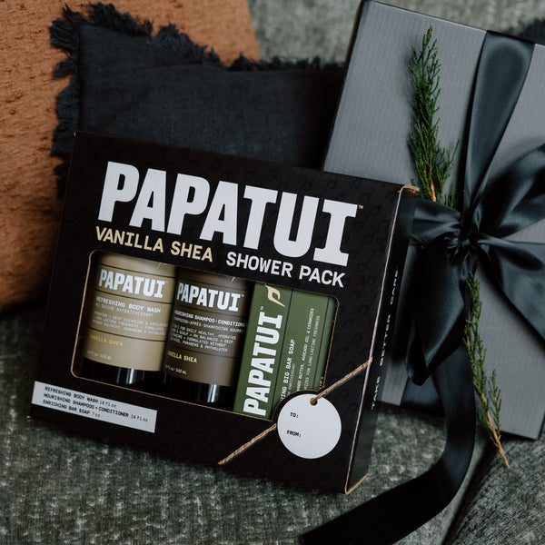 This image shows the vanilla shea shower pack gift set with other gifts to emphasize the holiday and giftable men's care.