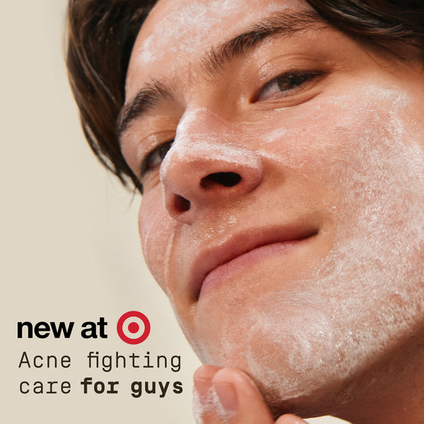 Close-up of a person applying PAPATUI Acne Fighting Cleanser to their face with text about acne fighting care for guys at Target.