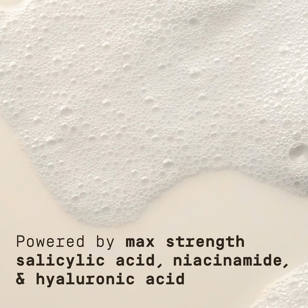 Text on a textured white background about max strength ingredients: salicylic acid, niacinamide, and hyaluronic acid.