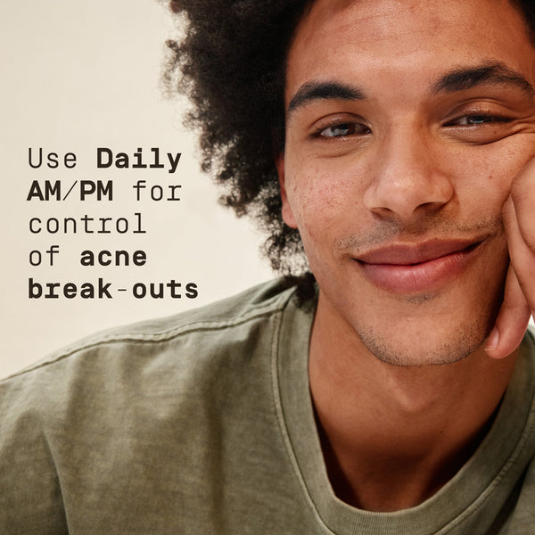 Man with a green shirt and text about using 'Daily AM/PM' for acne control.